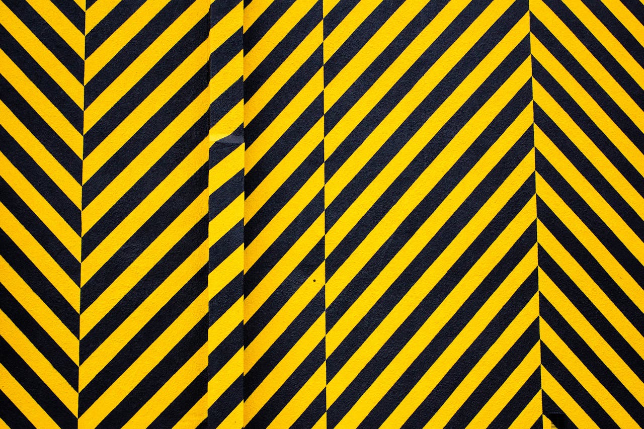 Dynamic yellow and black patterned background with bold diagonal stripes for creative design use.